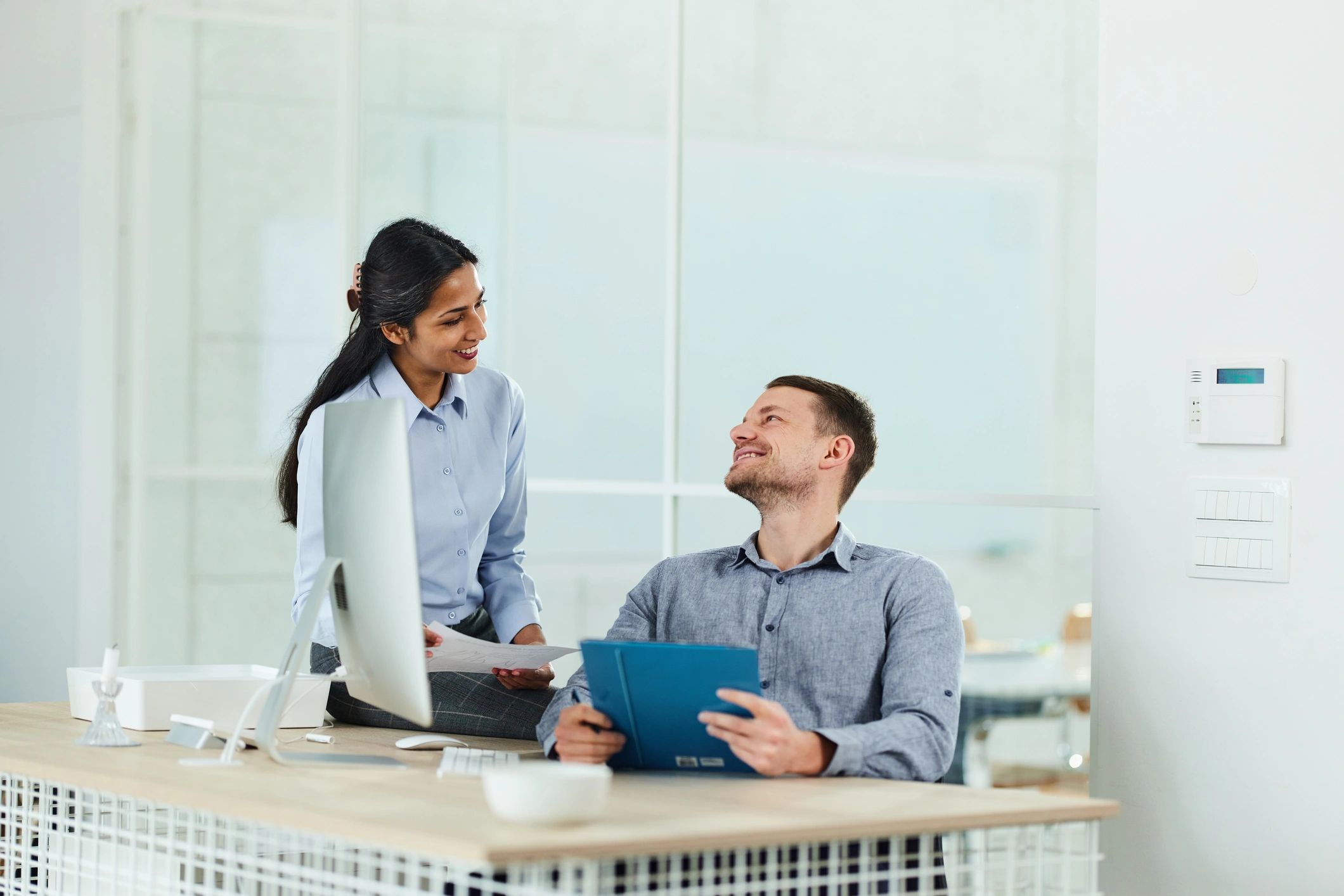 Education consultant meeting with a student in an office