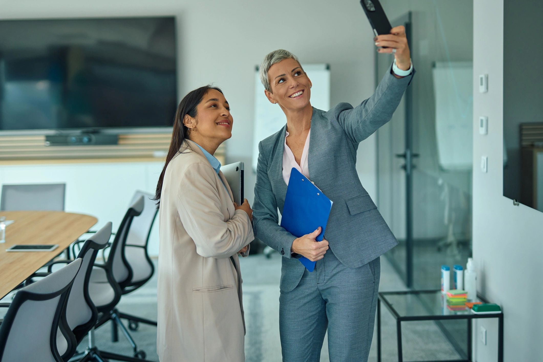 Two professionals smiling in an office